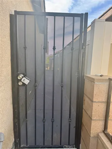 Right side of the house is gate leading to entry door.
