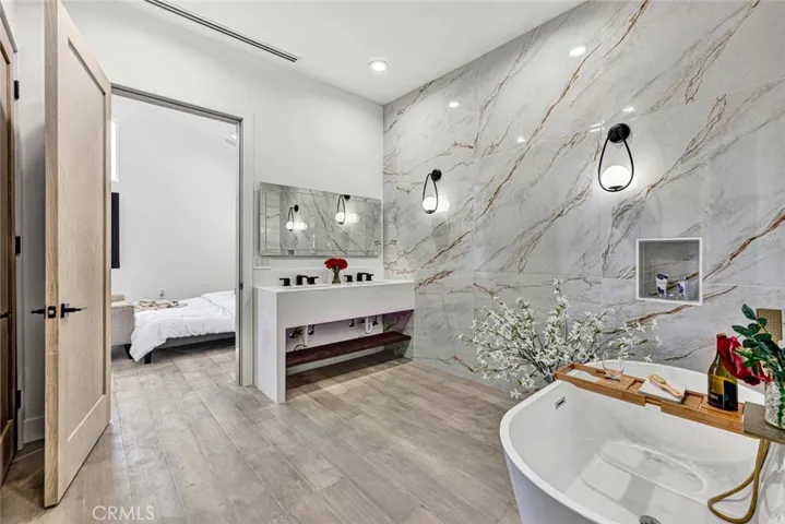 Elegance Abounds in the Primary Suite Spa-Style Bathroom with Freestanding Soaking Tub, Dual Sinks, and Giant Walk-In Shower