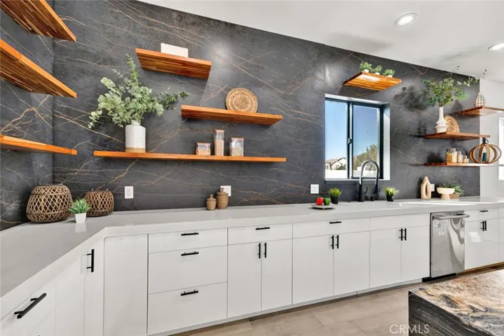  Quartz countertops, 2 sinks, chic floating shelving, and white gloss Thermofoil self-closing cabinetry