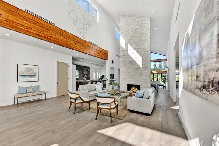 Great Room Style Floorplan with Formal Living Room and Large Family Room Divided by a Chiseled Marble Fireplace