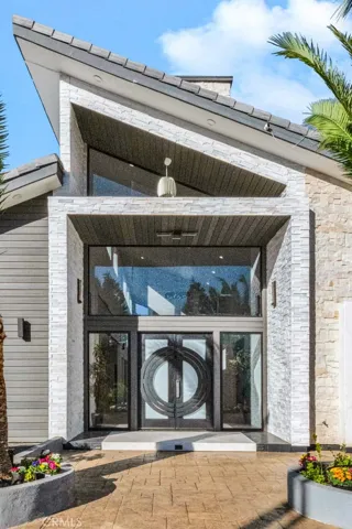 Custom Double Door Entry with Sidelights and a Transom Window Above. This Home is Light and Bright with Lots of Glass Windows and 26 Foot Ceilings.