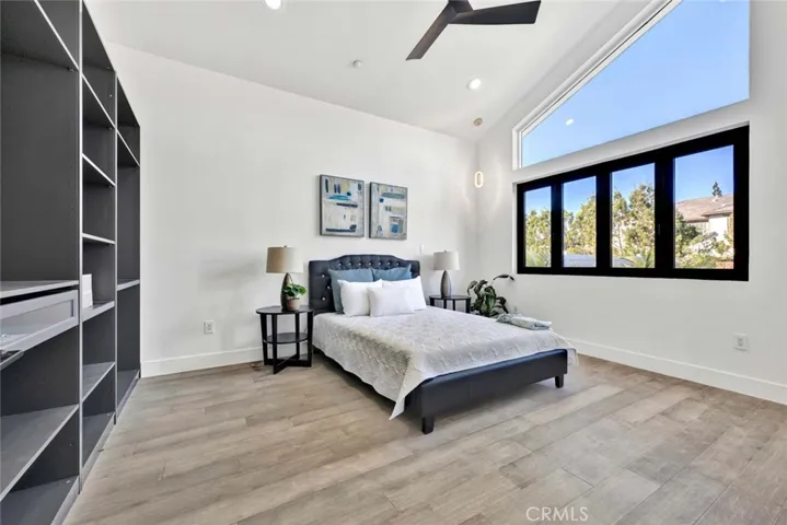 Bedroom # 2  Look at the size of the bedrooms! This is one of the secondary bedrooms. Vaulted ceiling, custom built-in shelving, lots of windows, ceiling fan, recessed lighting, wood laminate flooring and tons of space!