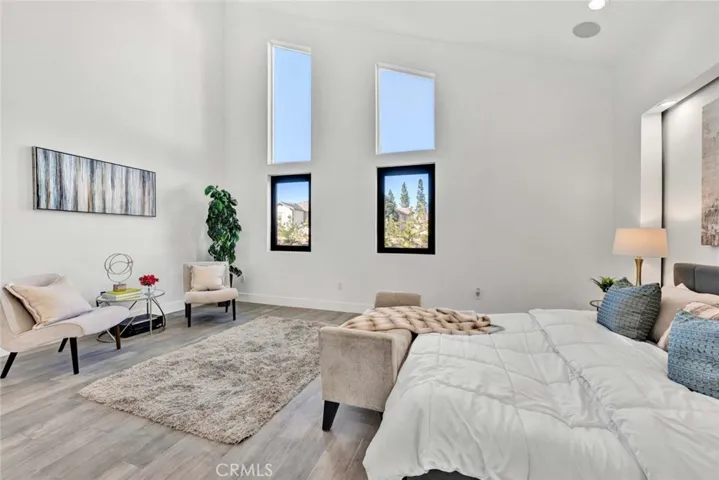 Primary Suite has Cathedral Ceiling, High Windows, Accent Lighting, Recessed Lighting, Ceiling Fan, a Giant Custom Organized Walk-In Closet and a Spa-Style Luxury Bathroom