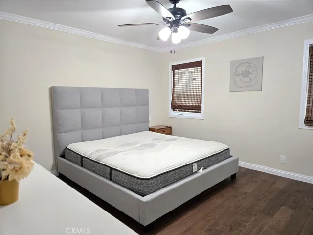 Primary Suite with ceiling fan and crown molding