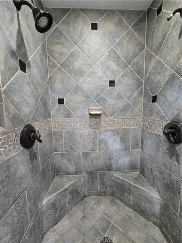 Walk in shower with built in seats in the primary bath