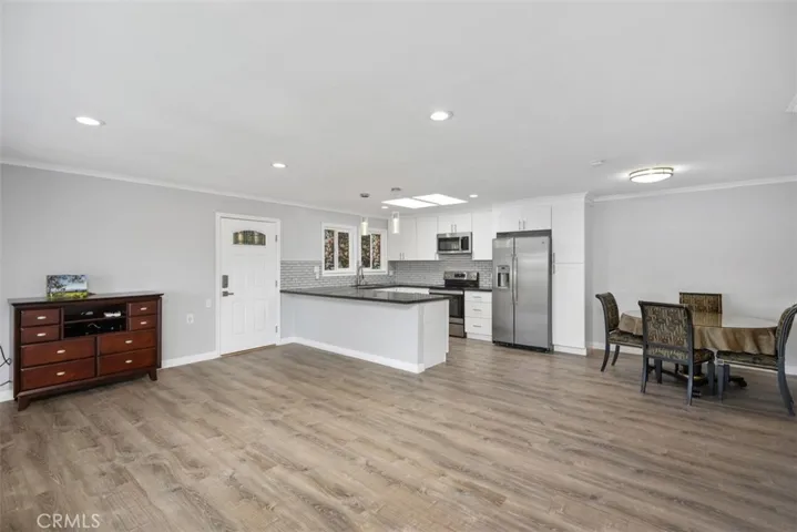 Living room to front door and kitchen