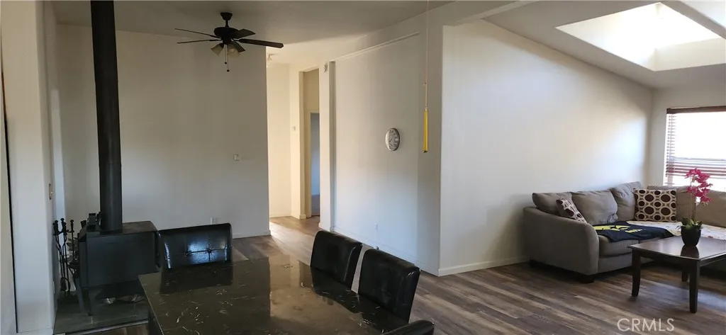 Large Living Roomwith wood stove and 2 lighted ceiling fans.