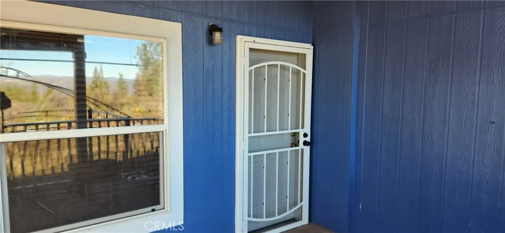Covered Entry Deck with Security Screen Door.