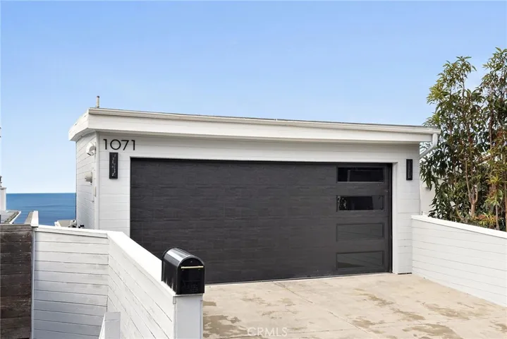 At street level, a two-car garage and a driveway with parking for two generously accommodate residents and guests.