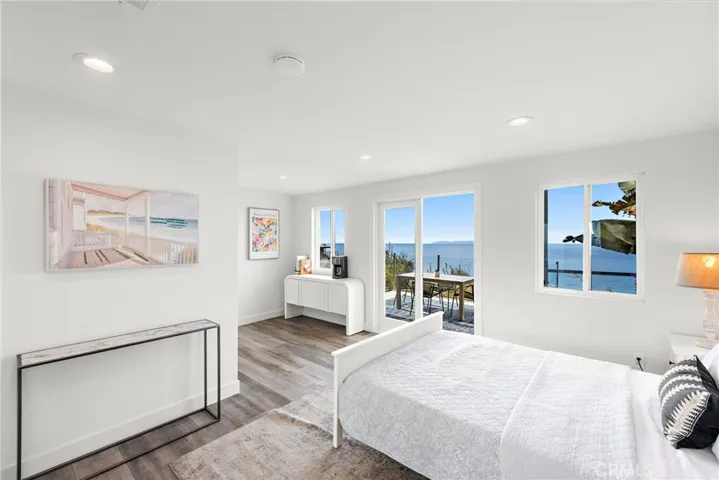 The lower level’s ensuite bedroom opens to a large deck with ocean views, and features a sitting area and private outdoor entrance, making it ideal as a home office or guest suite.