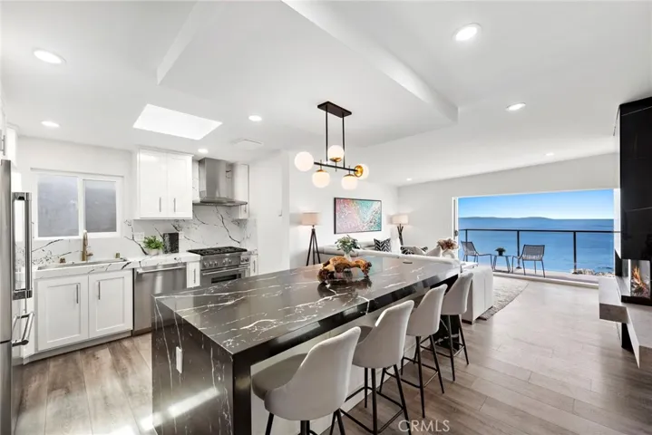 Enjoy sweeping unobstructed vistas of the sparkling Pacific Ocean, thousands of city lights, Catalina Island, colorful sunsets and the dramatic coastline from this fully upgraded contemporary showplace.