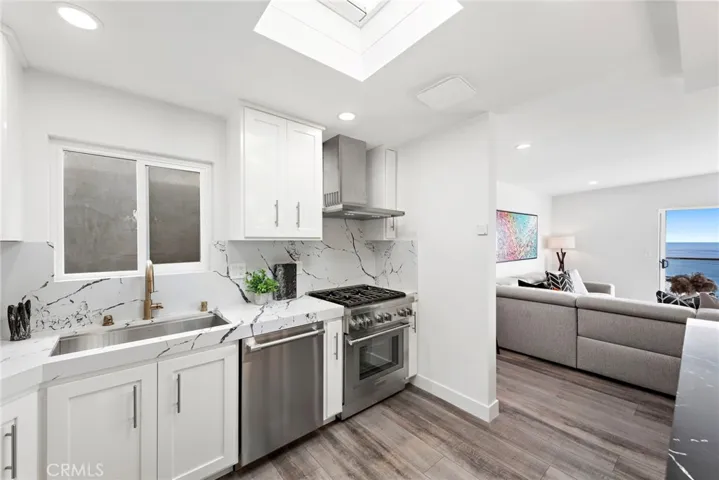 Chefs will appreciate a suite of stainless steel Thermador appliances, and a skylight welcomes natural light.