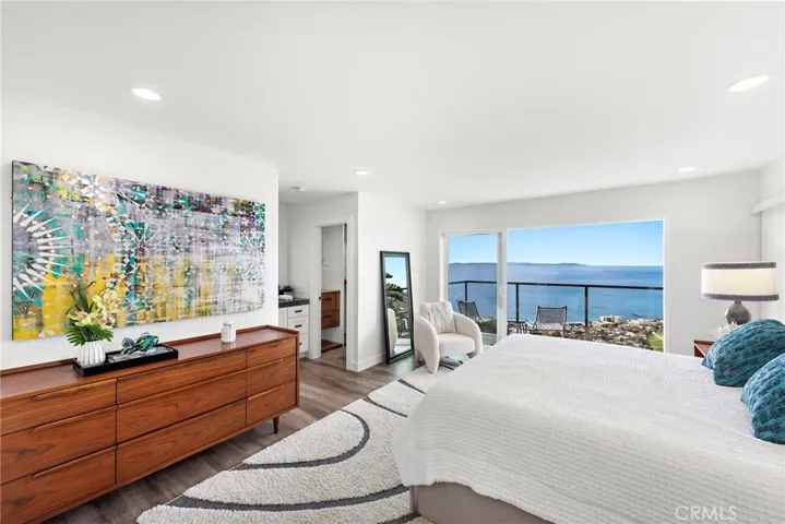 Spacious and private, the primary suite showcases an ocean-view balcony, chic bath and a walk-in closet with built-ins.