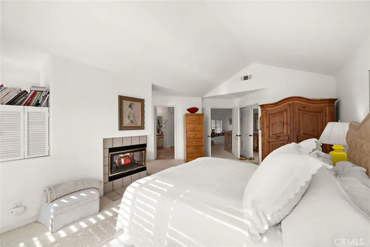 Primary bedroom with balcony and fireplace