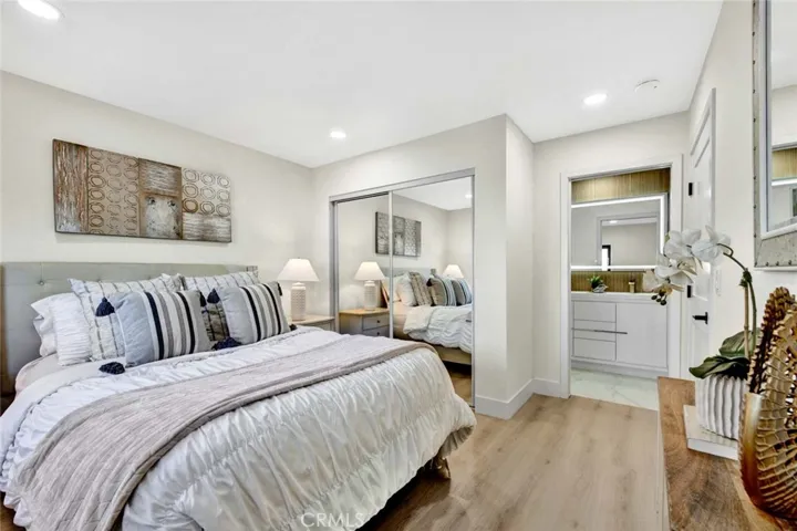 Downstairs primary suite has mirrored closet and luxurious ensuite bathroom
