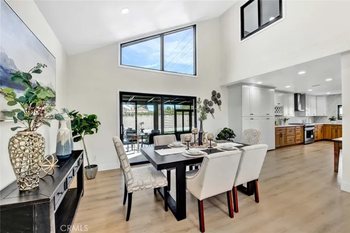 Formal dining room is open to the elegant formal living room and the gourmet kitchen, with sliders leading to an enormous enclosed patio