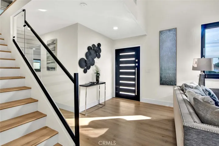 Designer Entry Door, Soaring Ceilings, Waterproof Wood Vinyl Flooring, Dual Pane Windows, Extensive LED Recessed Lighting, Staircase with Clear Glass Railing