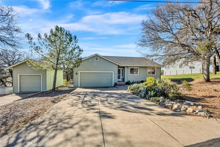 Front of house with extra garage/shop