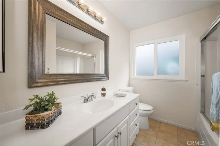 Hall bathroom enclosed tub/ shower with glass doors