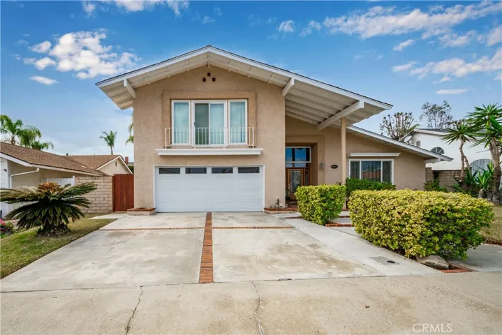 Front view of the home with double car garage and driveway room for 2 more cars
