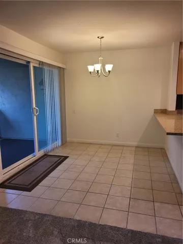 Dining room with tiled floors, extra eating area at kitchen counter top