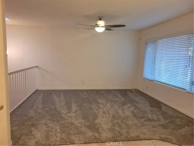 Spacious Living room with newly installed carpet floors and ceiling fan/lights