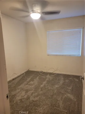 Bedroom #2 at main level with, newly installed carpet floors, ceiling fans/lights, horizontal blinds