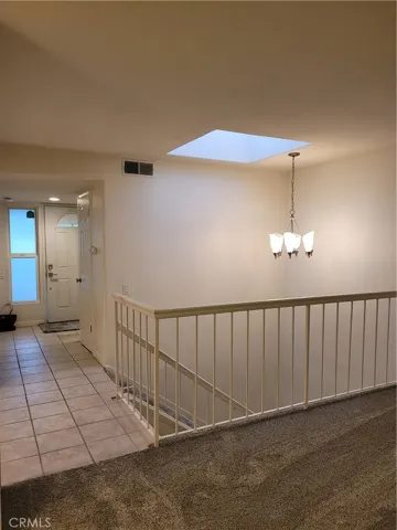 Front door entry at main level, skylight, tiled floors, stairs to downstairs bedrooms, bath