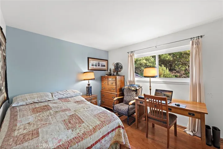 Upper bedroom with view out to rear yard and scenic hillside