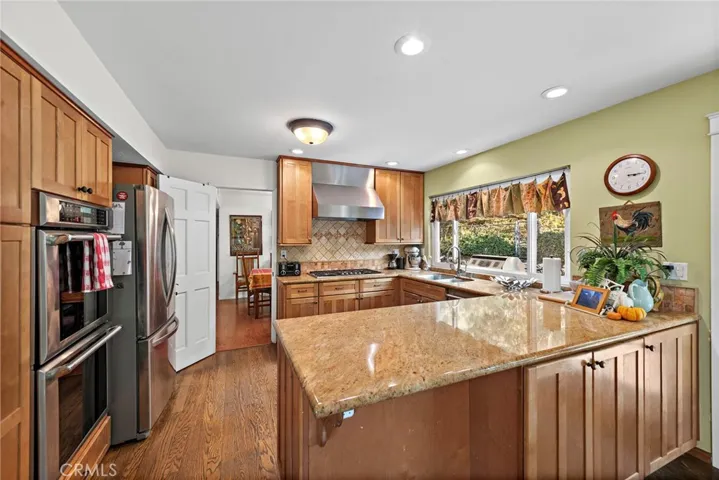 Kitchen with stainless steel appliances, updated cabinetry & recessed lighting