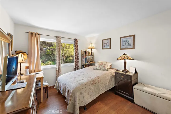 Additional upper bedroom with rear yard and hillside views