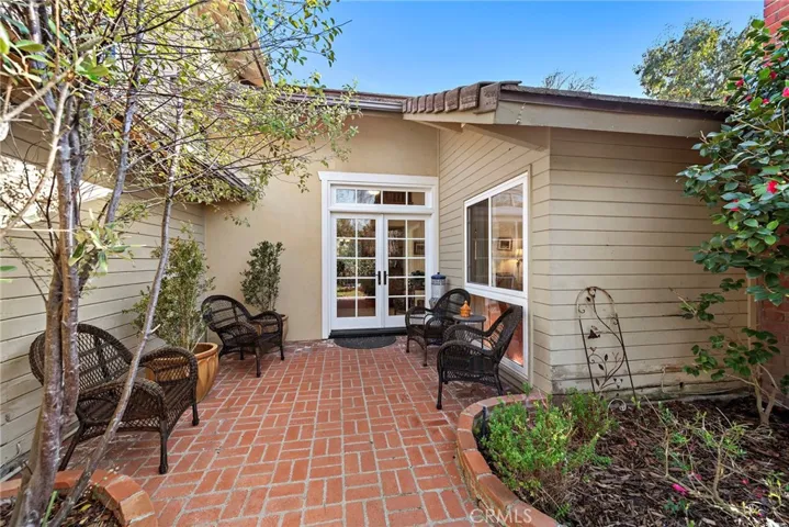 Brick-laid entryway leading to double French front doors