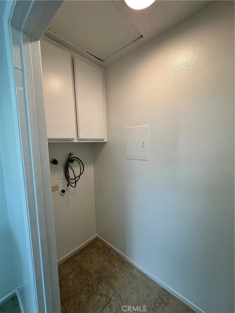 Laundry area with cupboards.