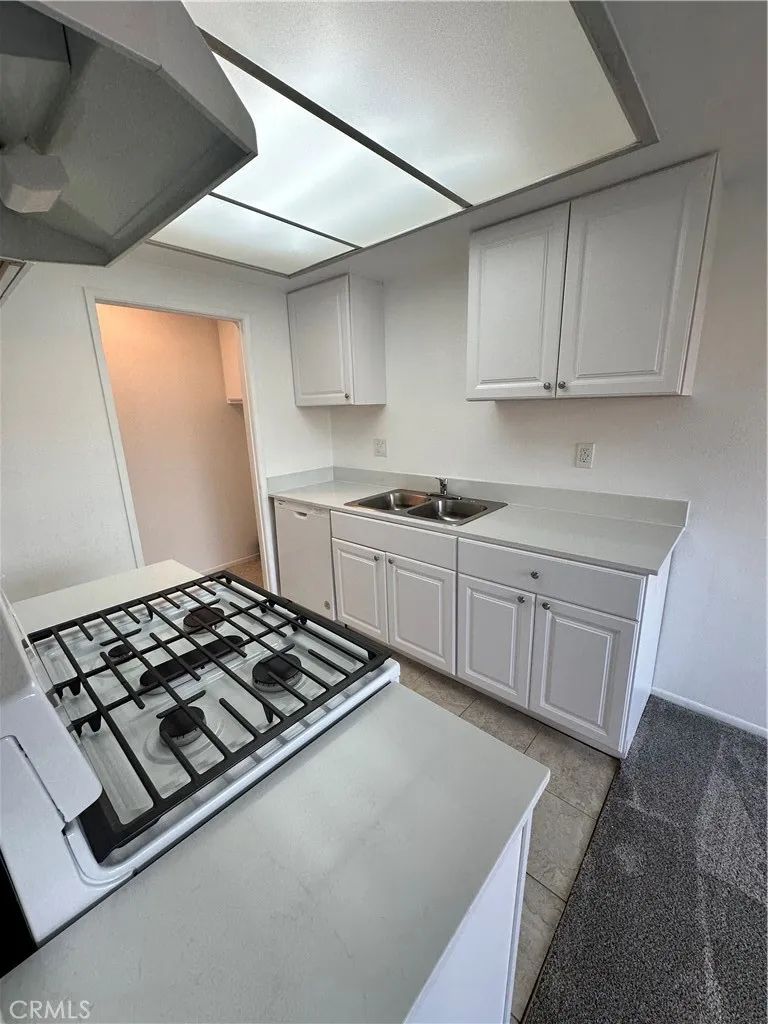 Any other view of kitchen with entry into the laundry area inside your unit.