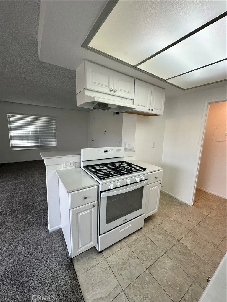 Kitchen updated with tile flooring and oven/range.