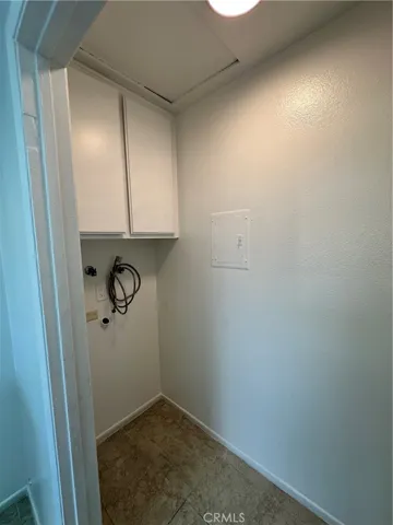 Laundry area with cupboards.