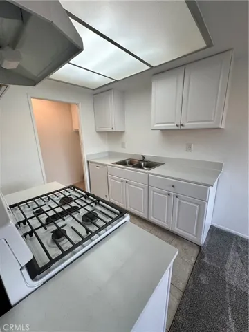 Any other view of kitchen with entry into the laundry area inside your unit.