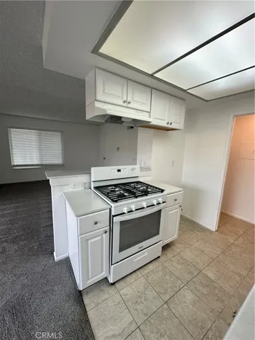 Kitchen updated with tile flooring and oven/range.