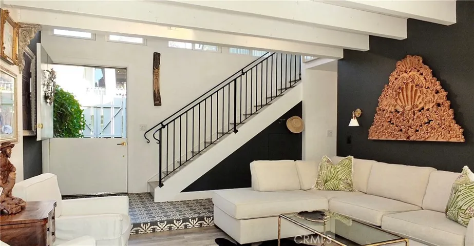 Custom tile entrance with iron stair case.