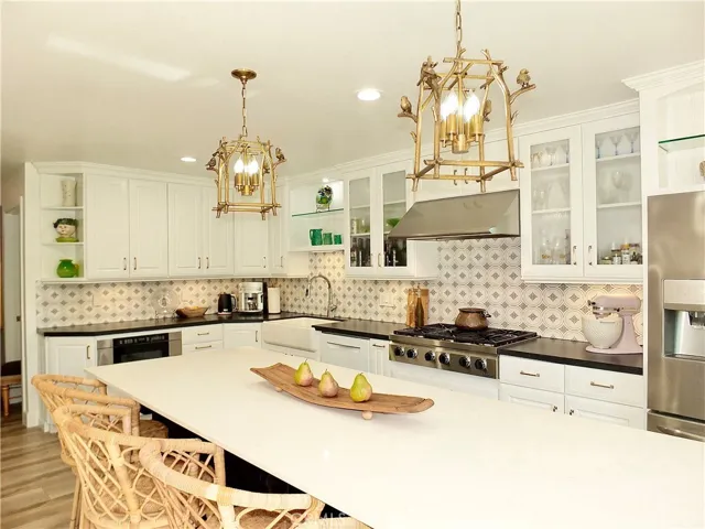 Dacor gas cooktop, double ovens, microwave and exhaust fan.