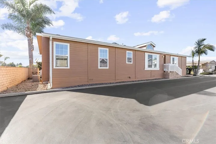 Side front door coroner lot and back of the home with AC