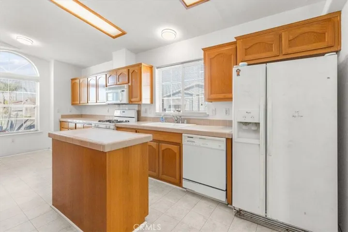 Kitchen un-staged with island and Refrigerator included