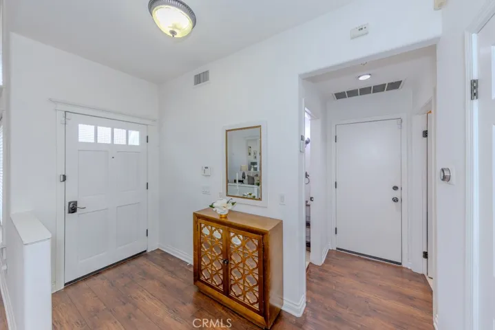 View of the front entry with the hallway to the garage access door.

