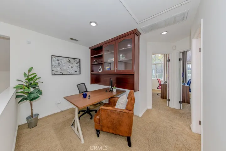 Loft/study area on the second level with access to bedrooms and bathroom.