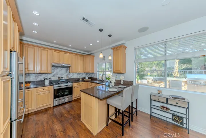 View of the kitchen with an island and bar seating.