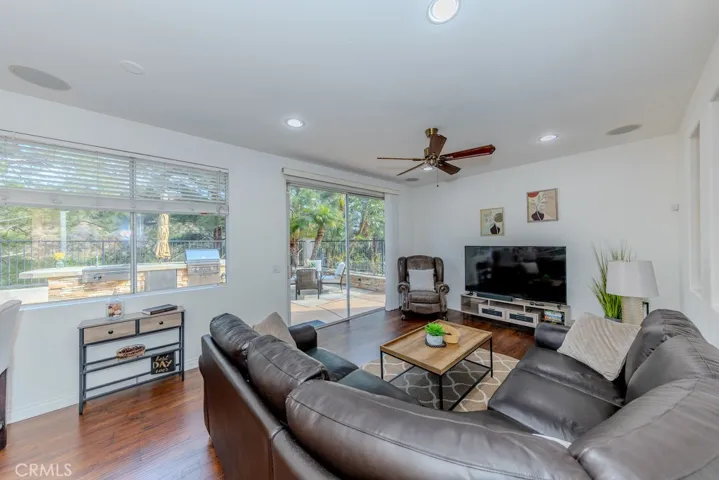 Family room with ceiling fan, recessed lighting, and slider access to the backyard.