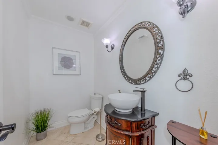 Downstairs half bathroom with trendy bowl sink.