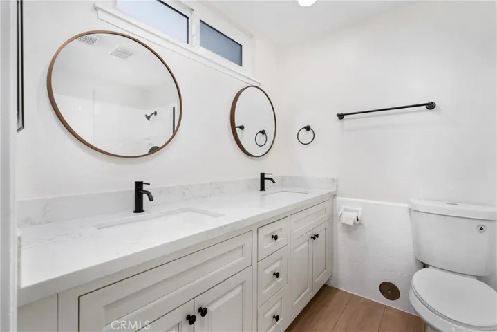 Downstair primary bathroom with quartz countertops, dual sinks, and recessed lighting!
