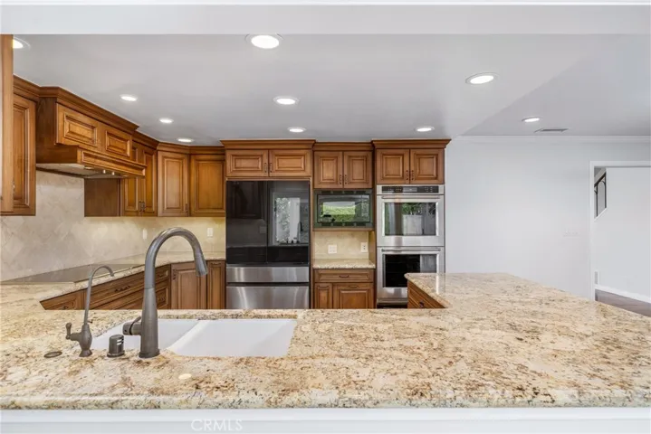 High end appliances including a 5-burner electric cooktop, a double oven with warming drawer, microwave and a new refrigerator!