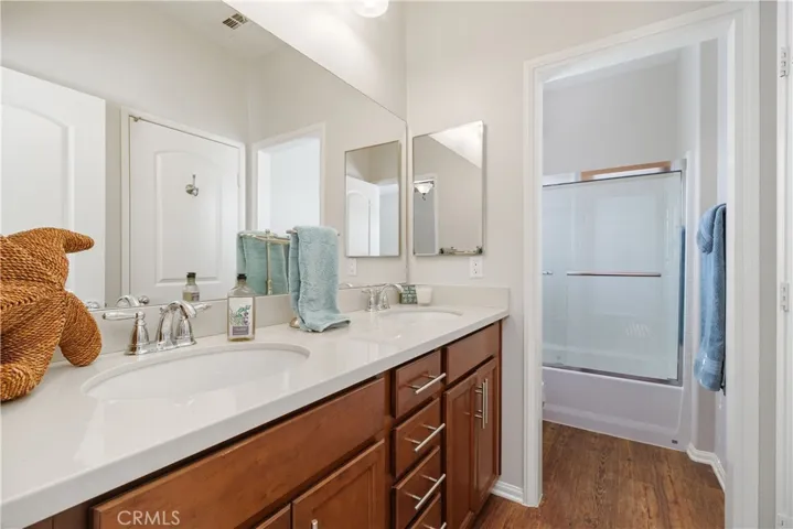 Jack and Jill bathroom with dual sinks and tub shower combination.